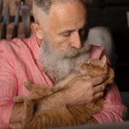 Older man holding a cat