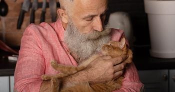 Older man holding a cat