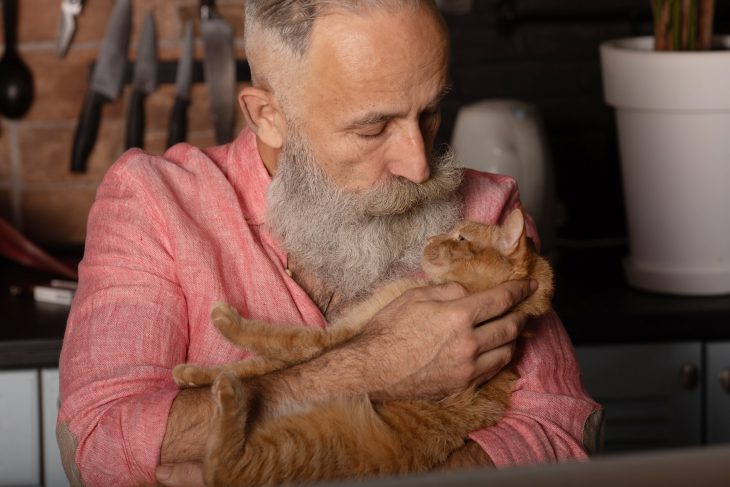 Older man holding a cat