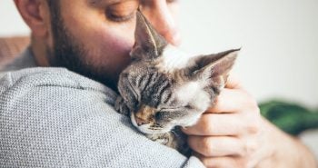 Man cuddling with cat